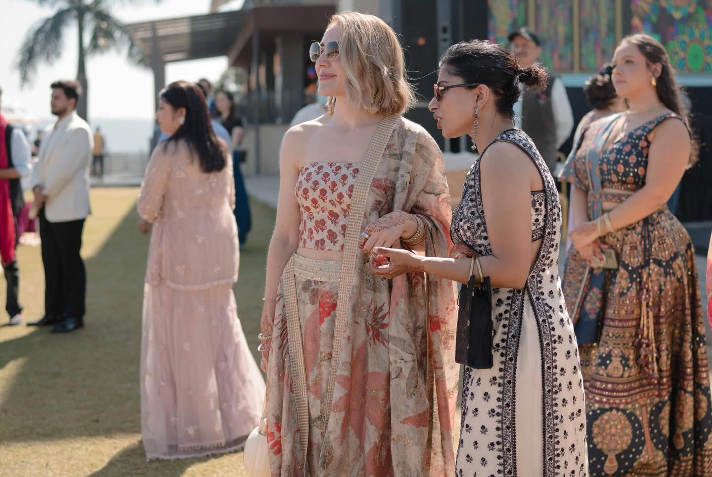 Kirsten in Indian formal wear with friends at an outdoor wedding celebration in India